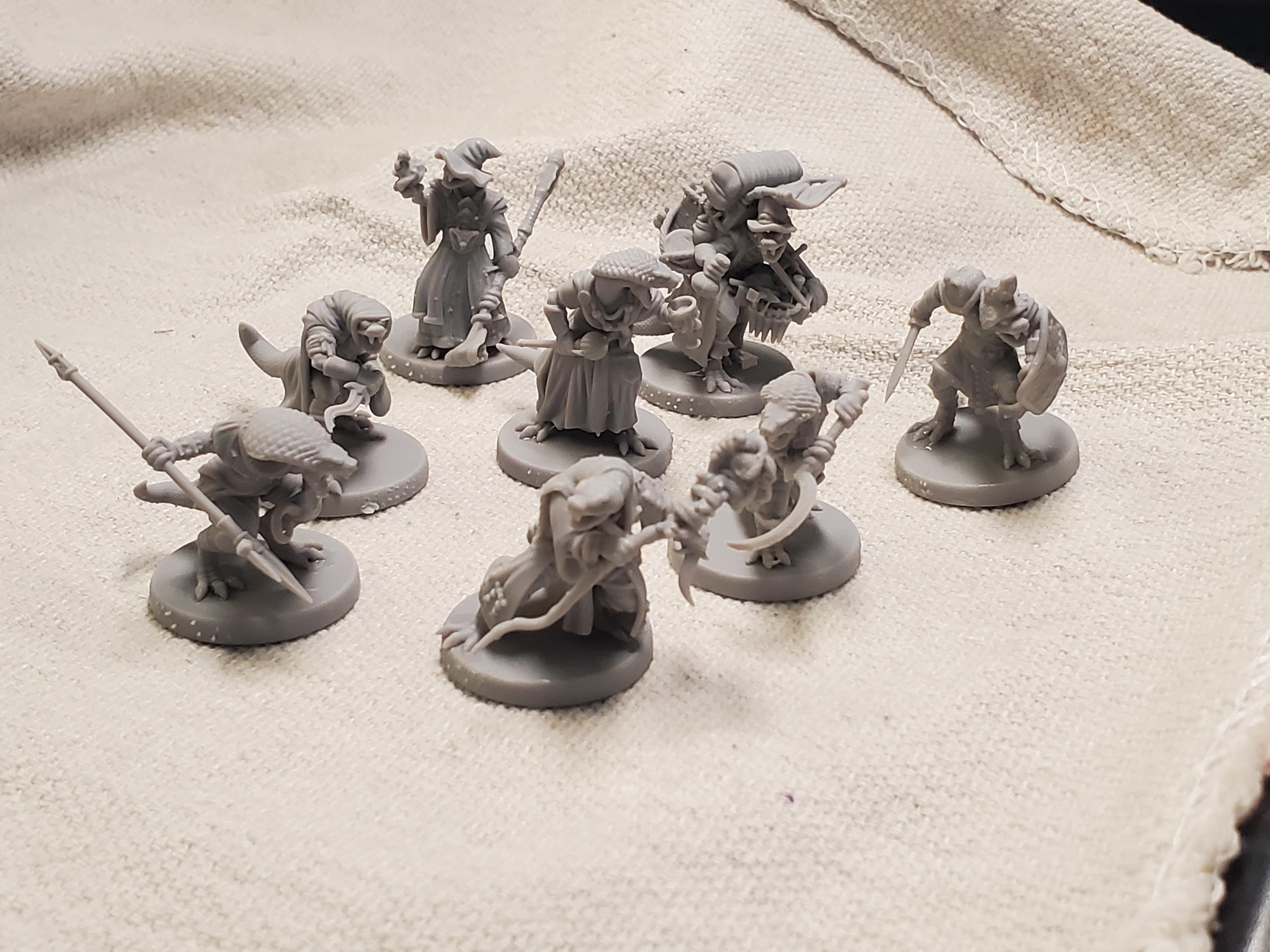 Unpainted serpent folk miniatures from an Etsy order