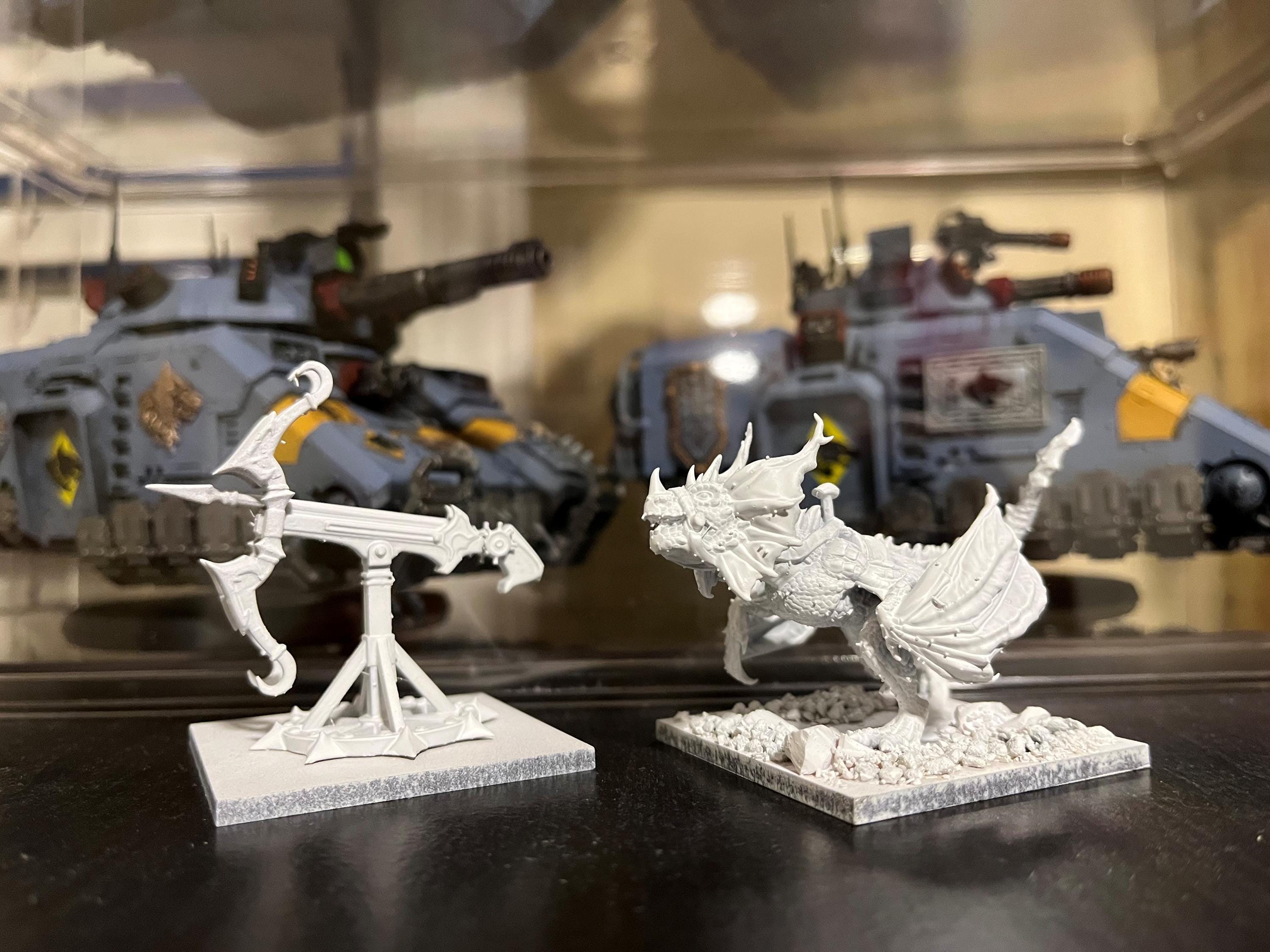 Unpainted angry wyvern miniatures from an Etsy order